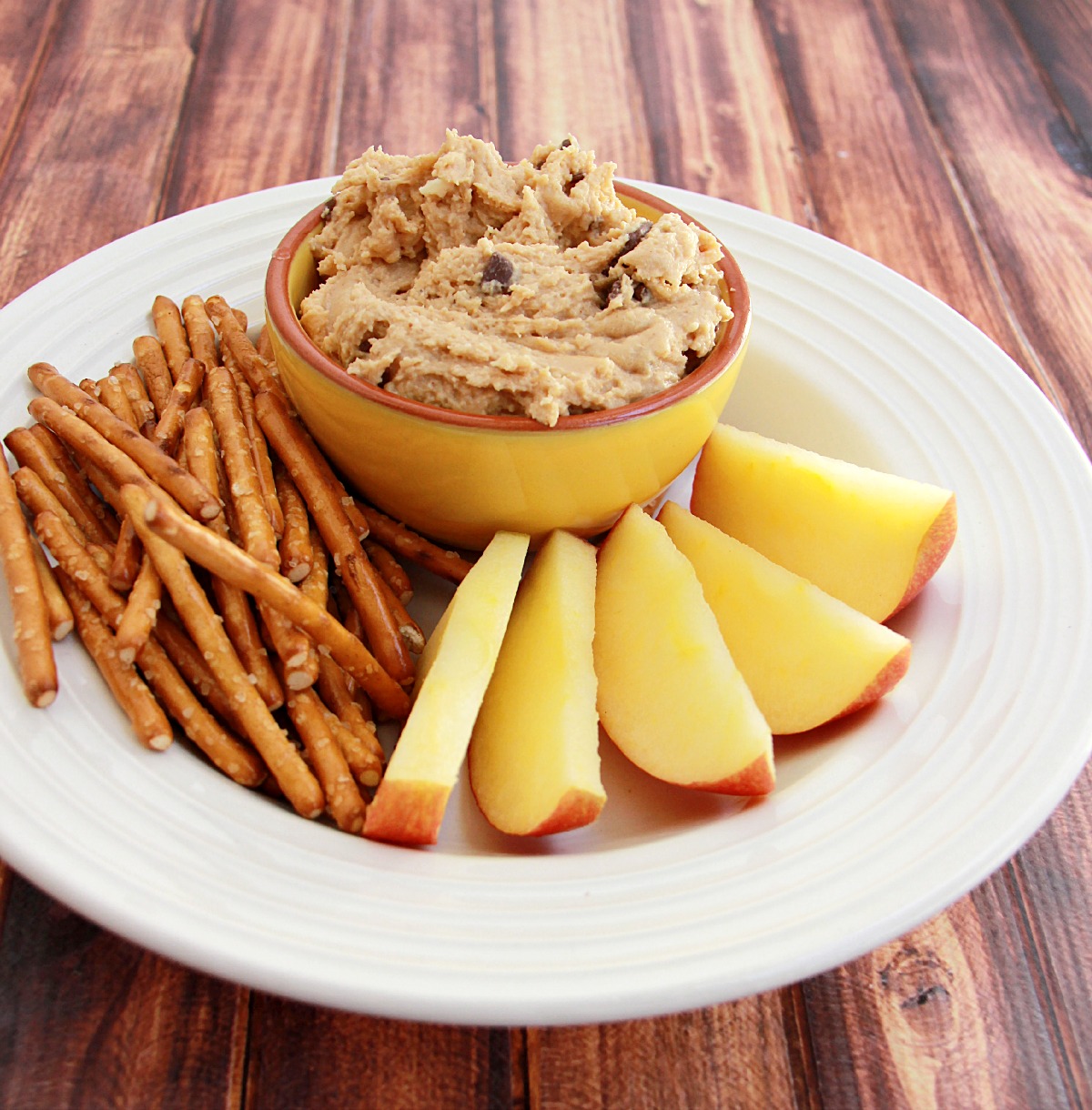 Cookie Dough Dip served with pretzels and apples.