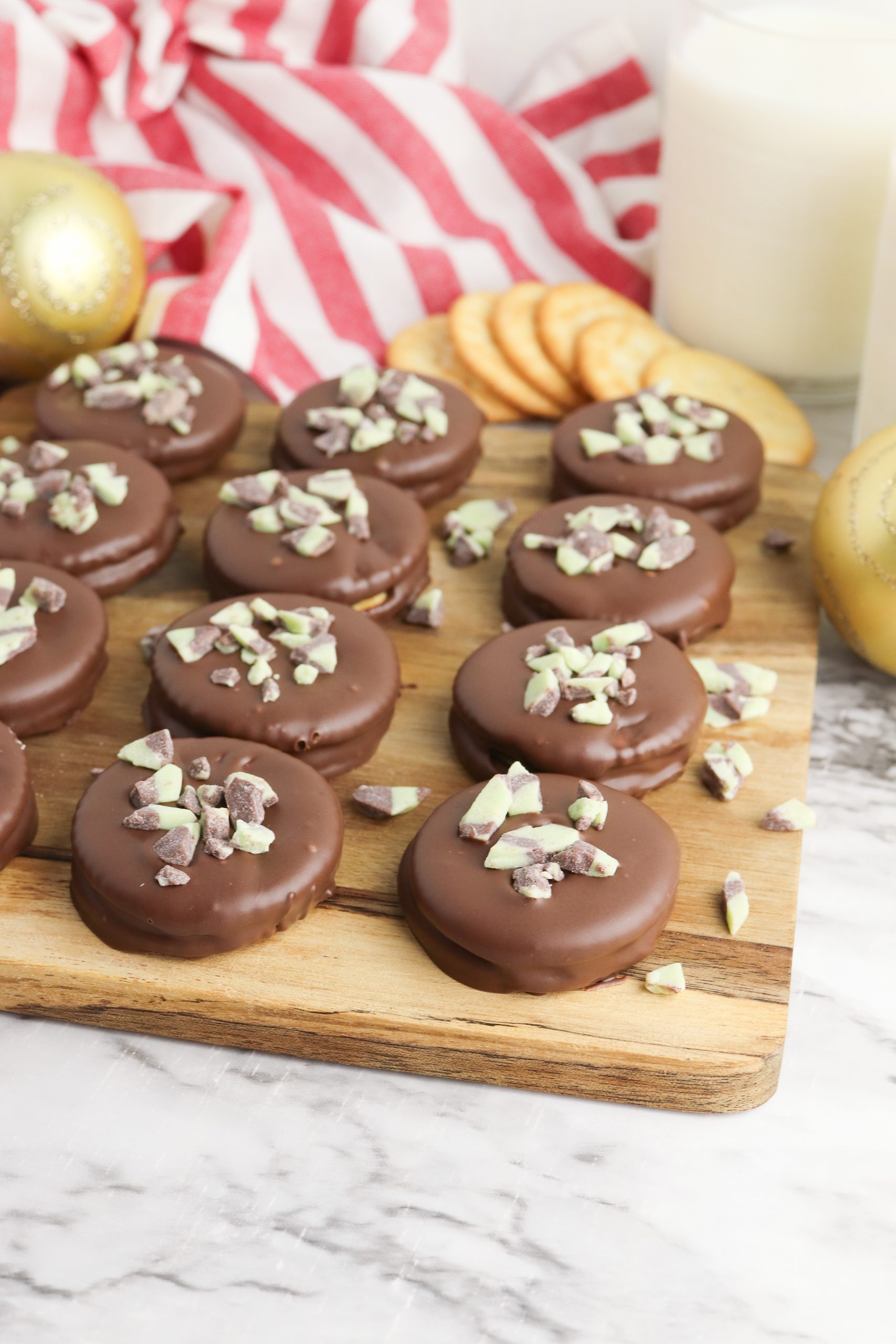 Homemade thin mint cookies with ritz crackers on a wooden board