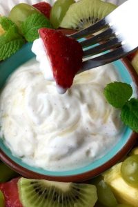 grape salad with a strawberry on a fork