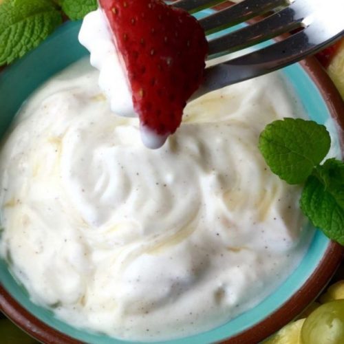 grape salad with a strawberry on a fork