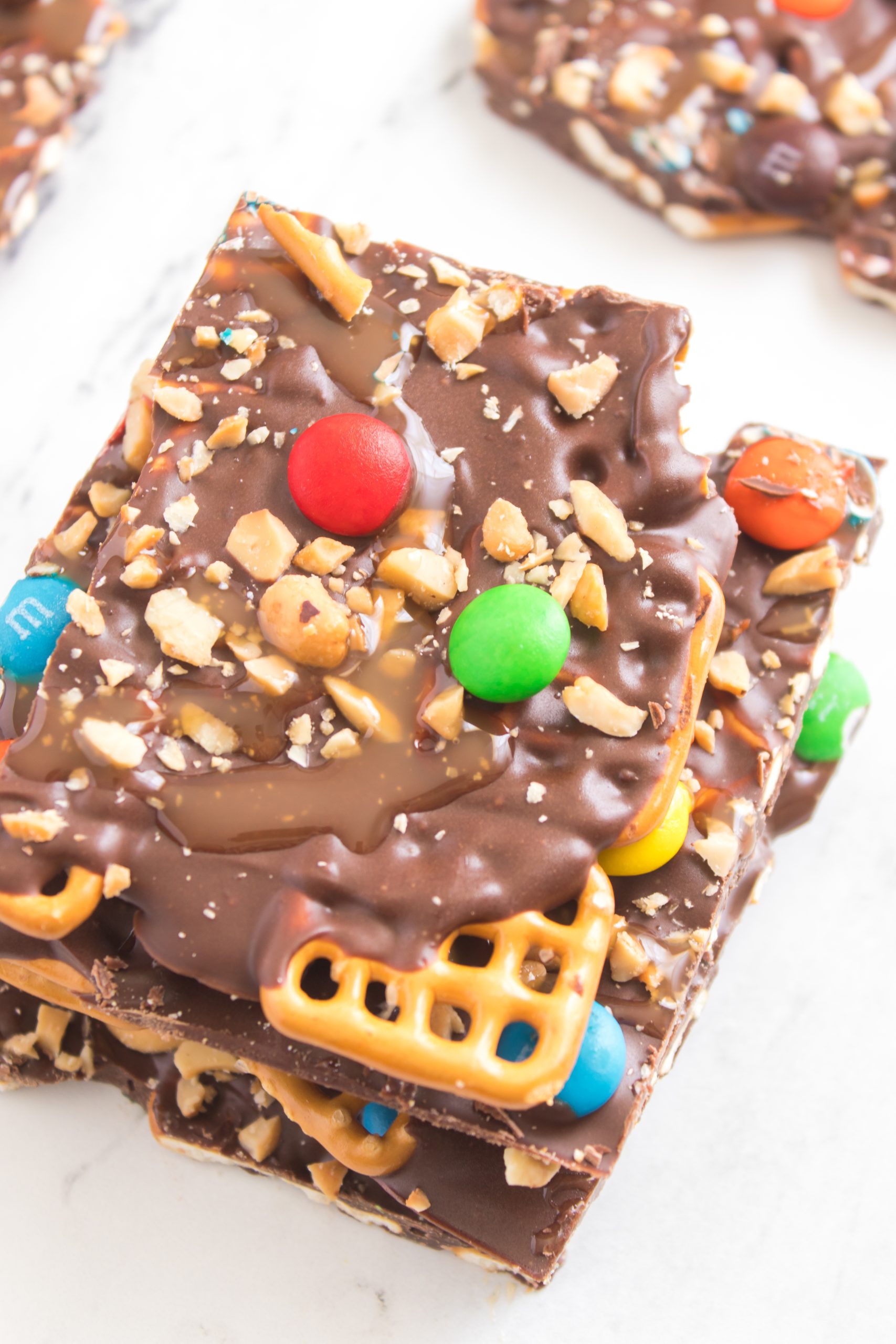 Picture of the chocolate caramel pretzel bark cut into a piece 