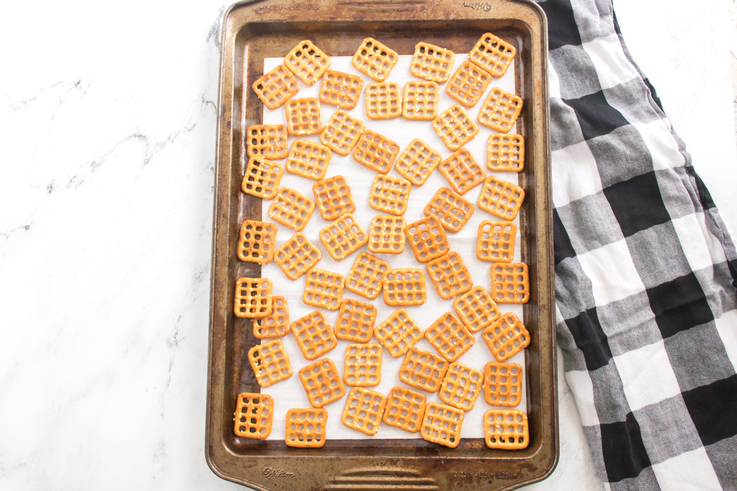 parchment paper with pretzels spread across it