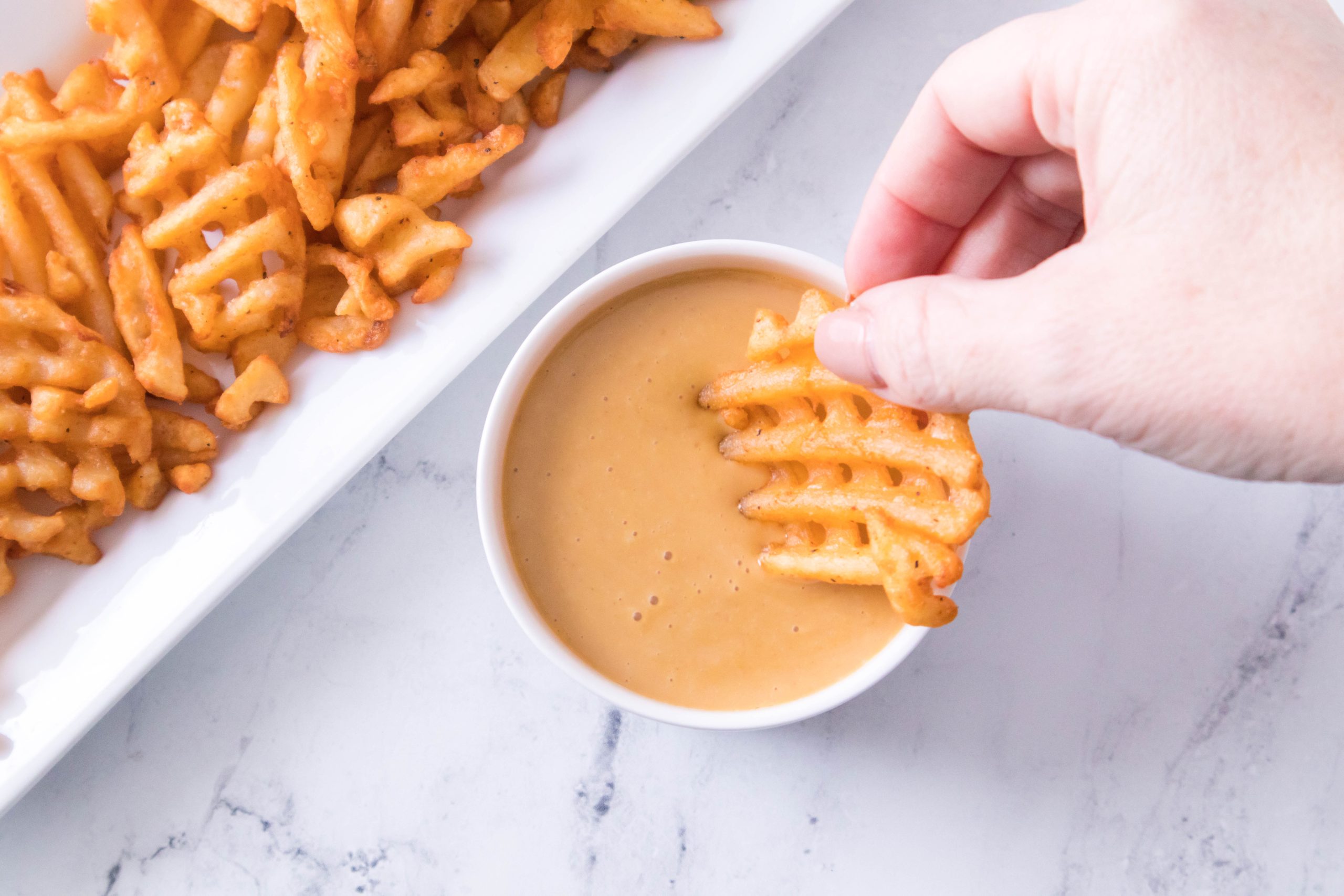 waffle fry dipped in Copycat Chick Fil a Sauce