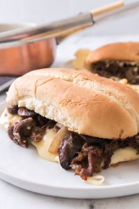 Philly cheesesteak on a white plate