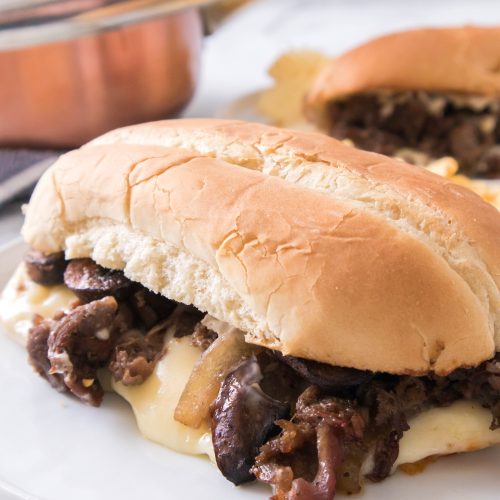 Philly cheesesteak on a white plate