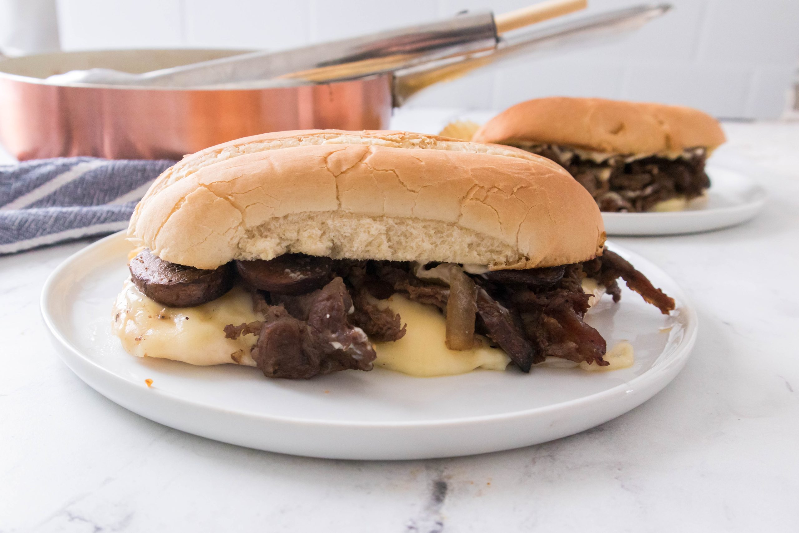 Philly cheesesteak on a white plate