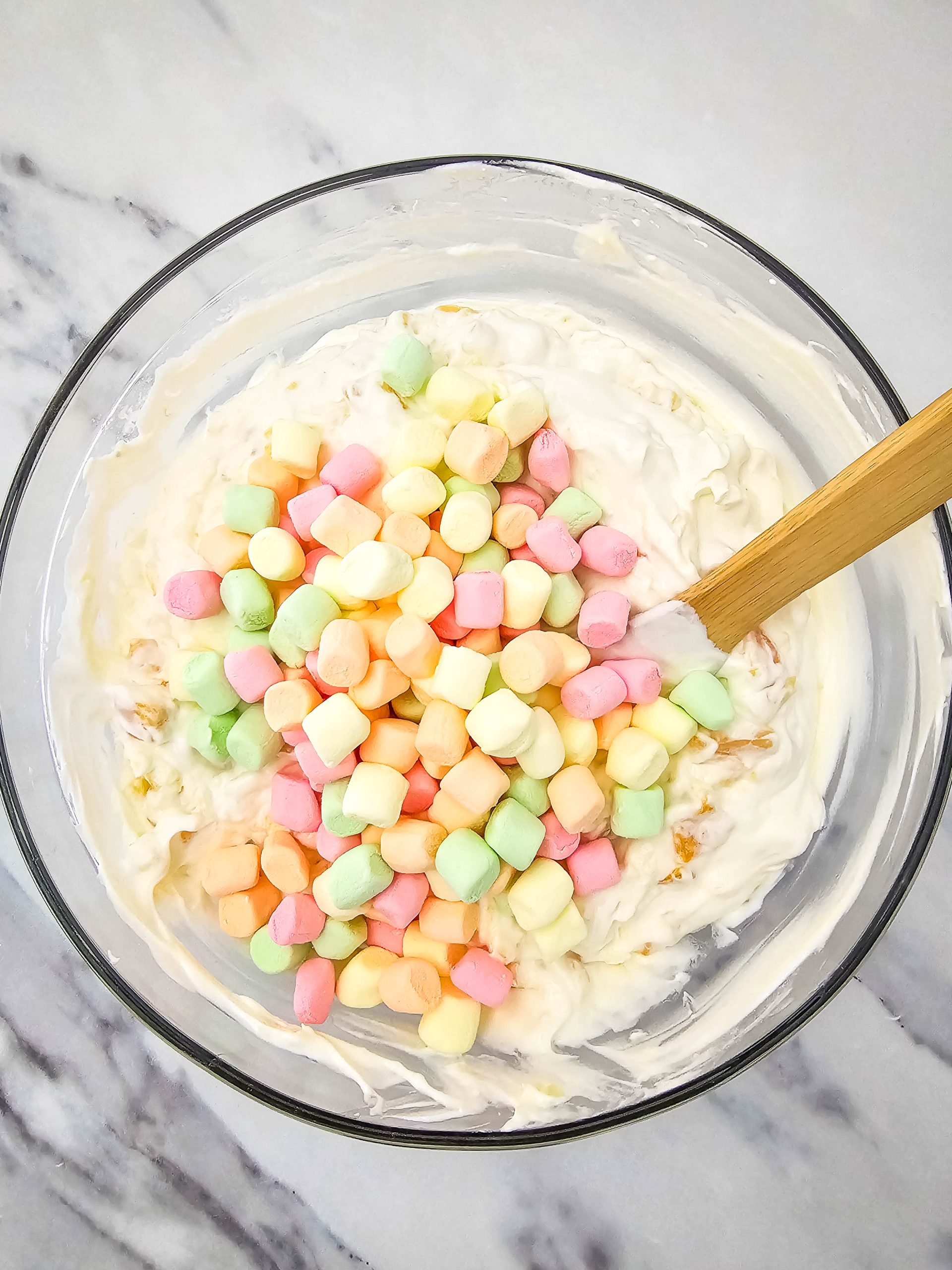 adding marshmallows to the bowl