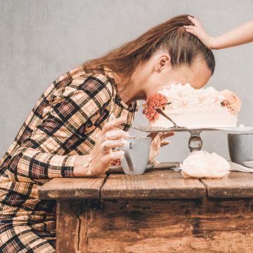 lady getting face smashed into cake