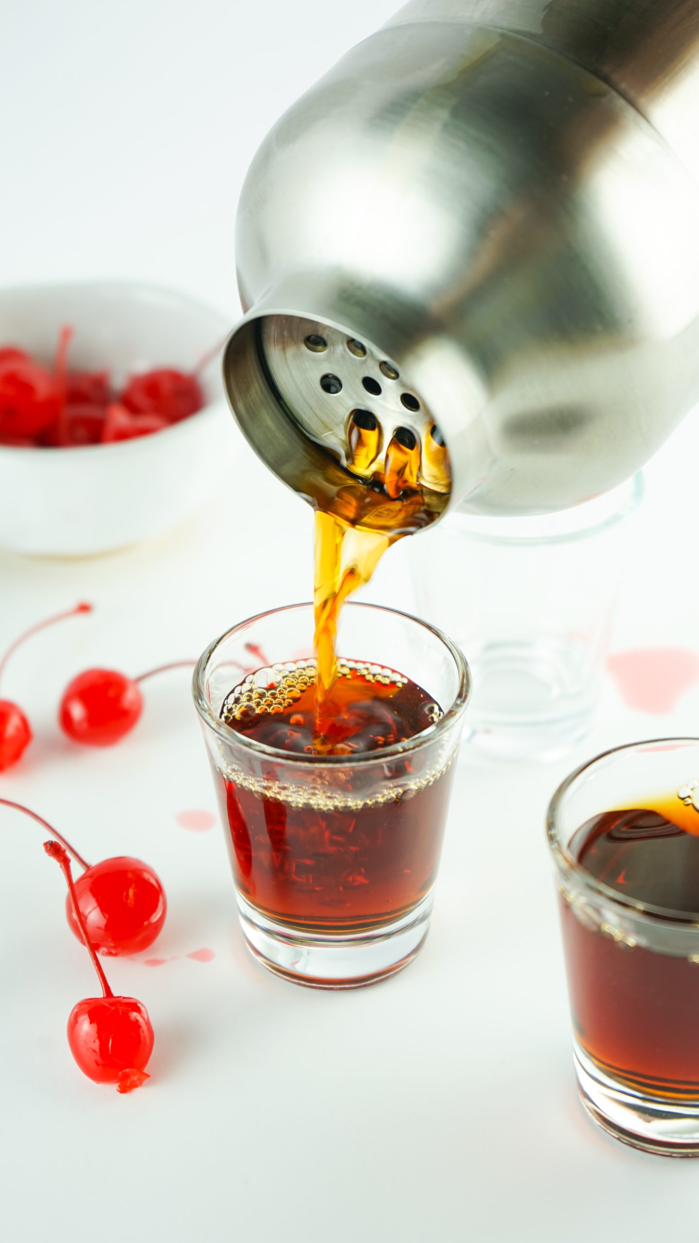 straining into shot glass