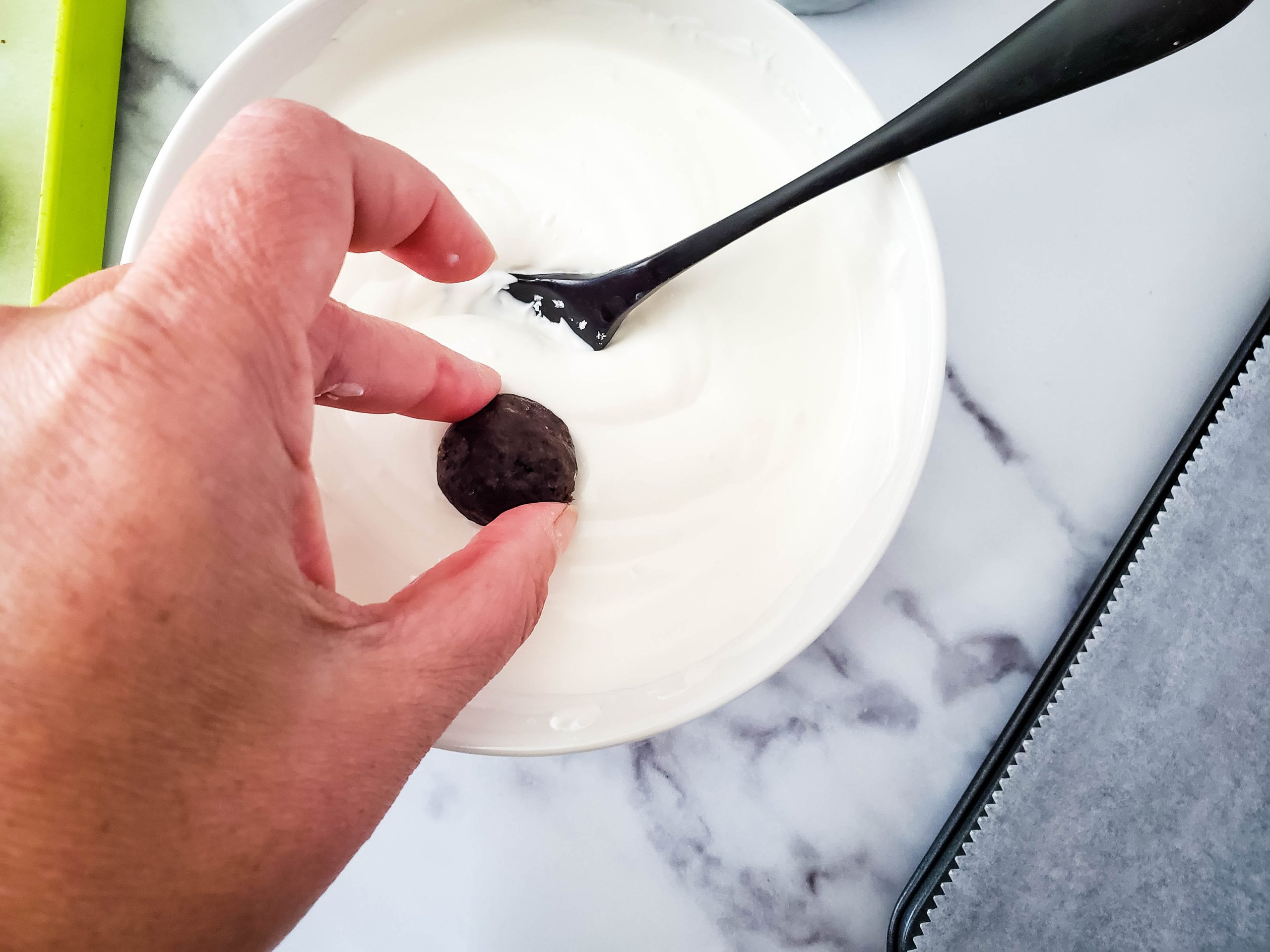 dipping the mummy balls in the white chocolate