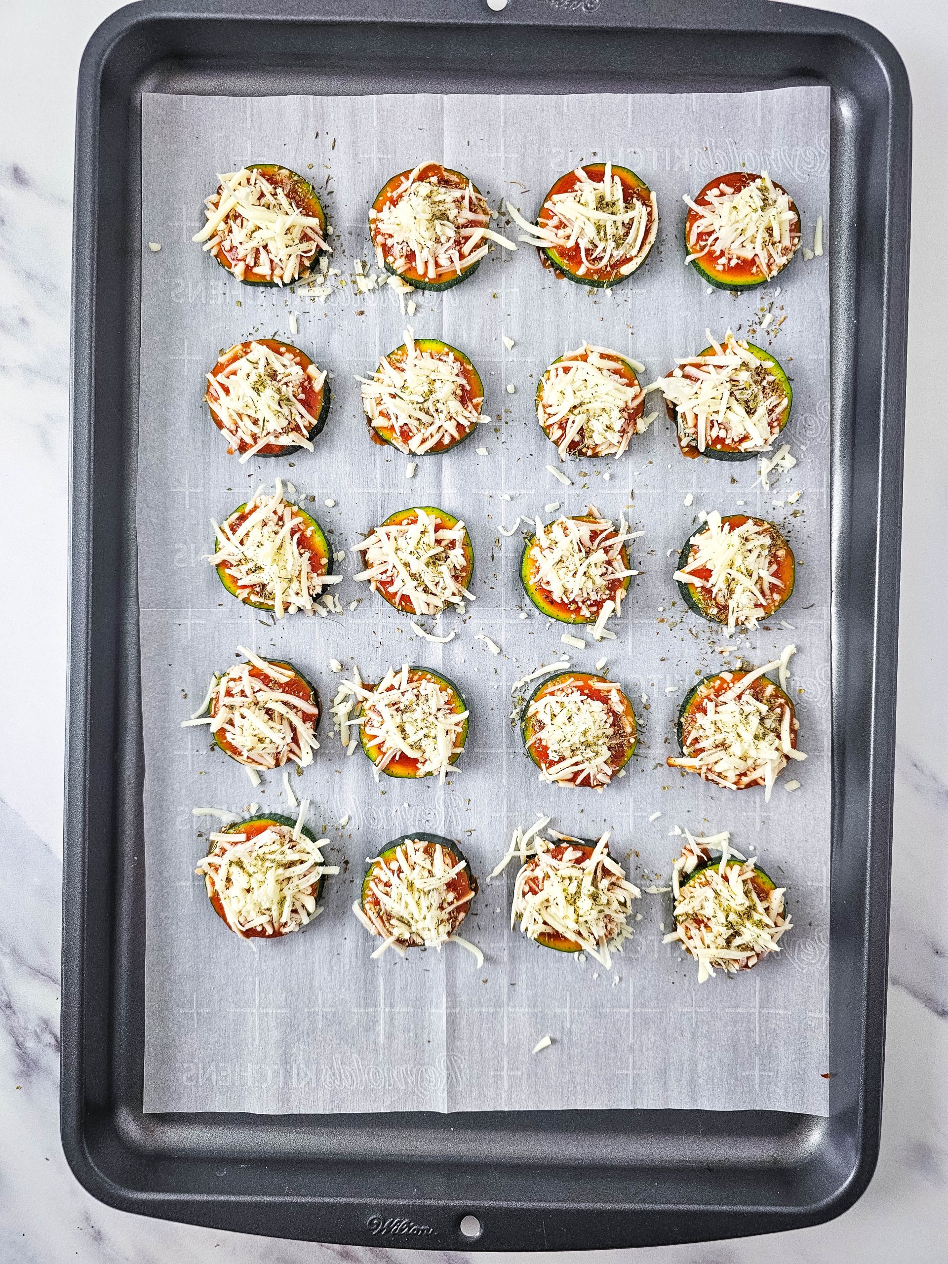 the pizzas on the cookie sheet