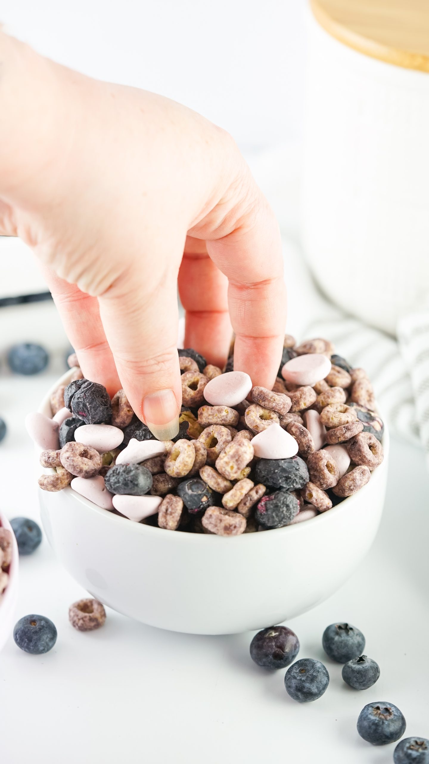 hand getting the baby trail mix from the bowl