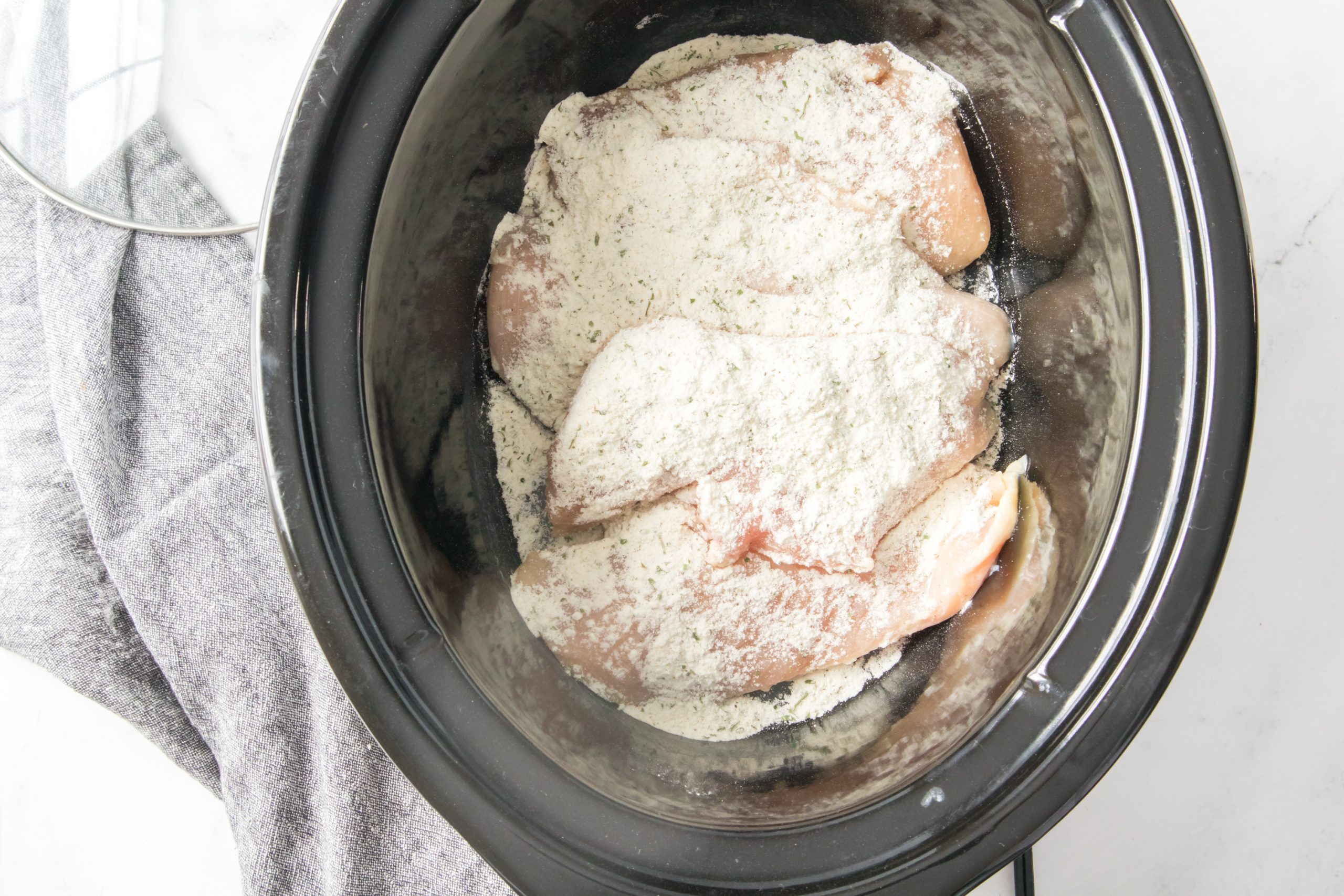 chicken and seasoning in the slow cooker