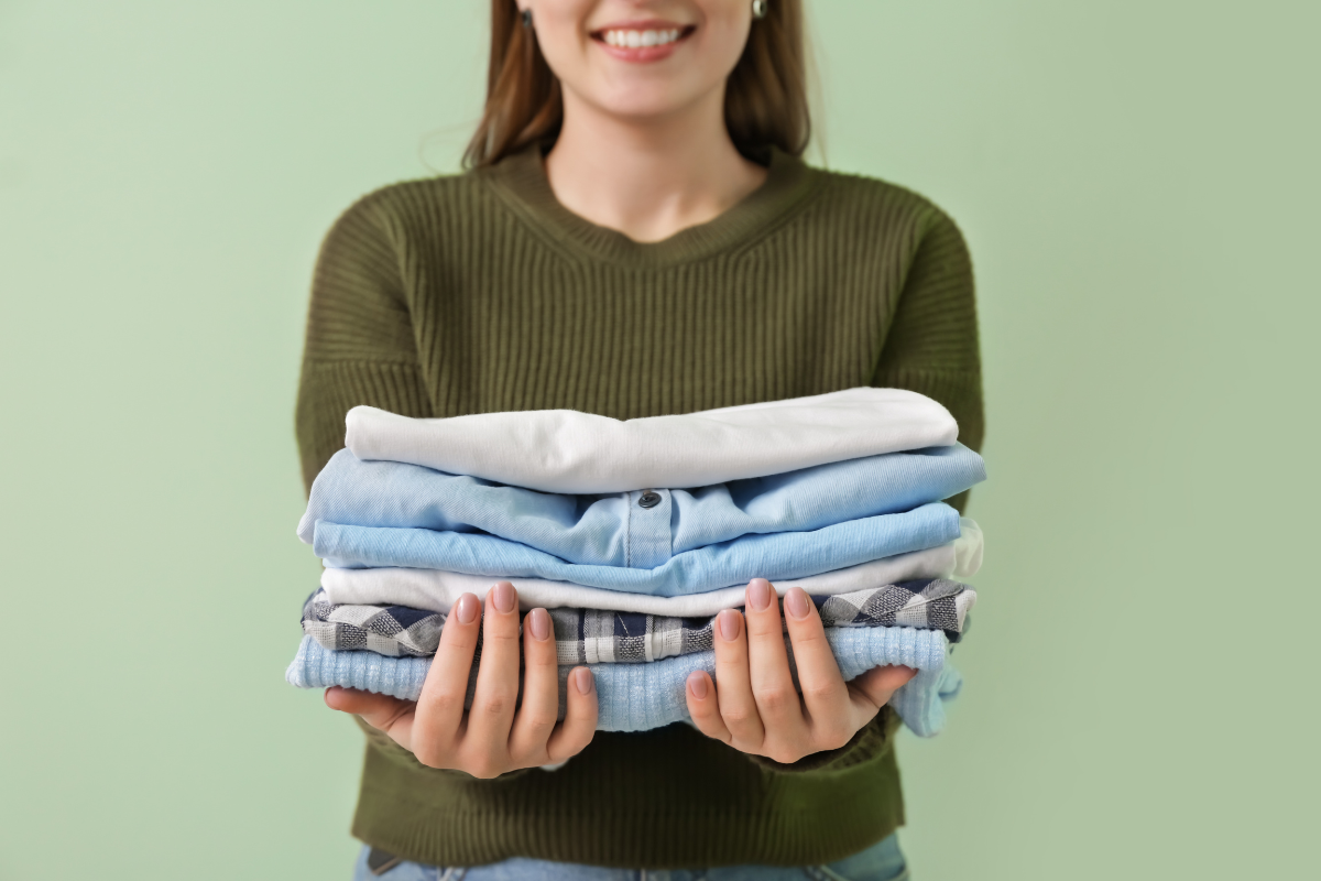 holding folded clothes