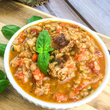 close up of lentil and chorizo soup with diced vegetables and sausage