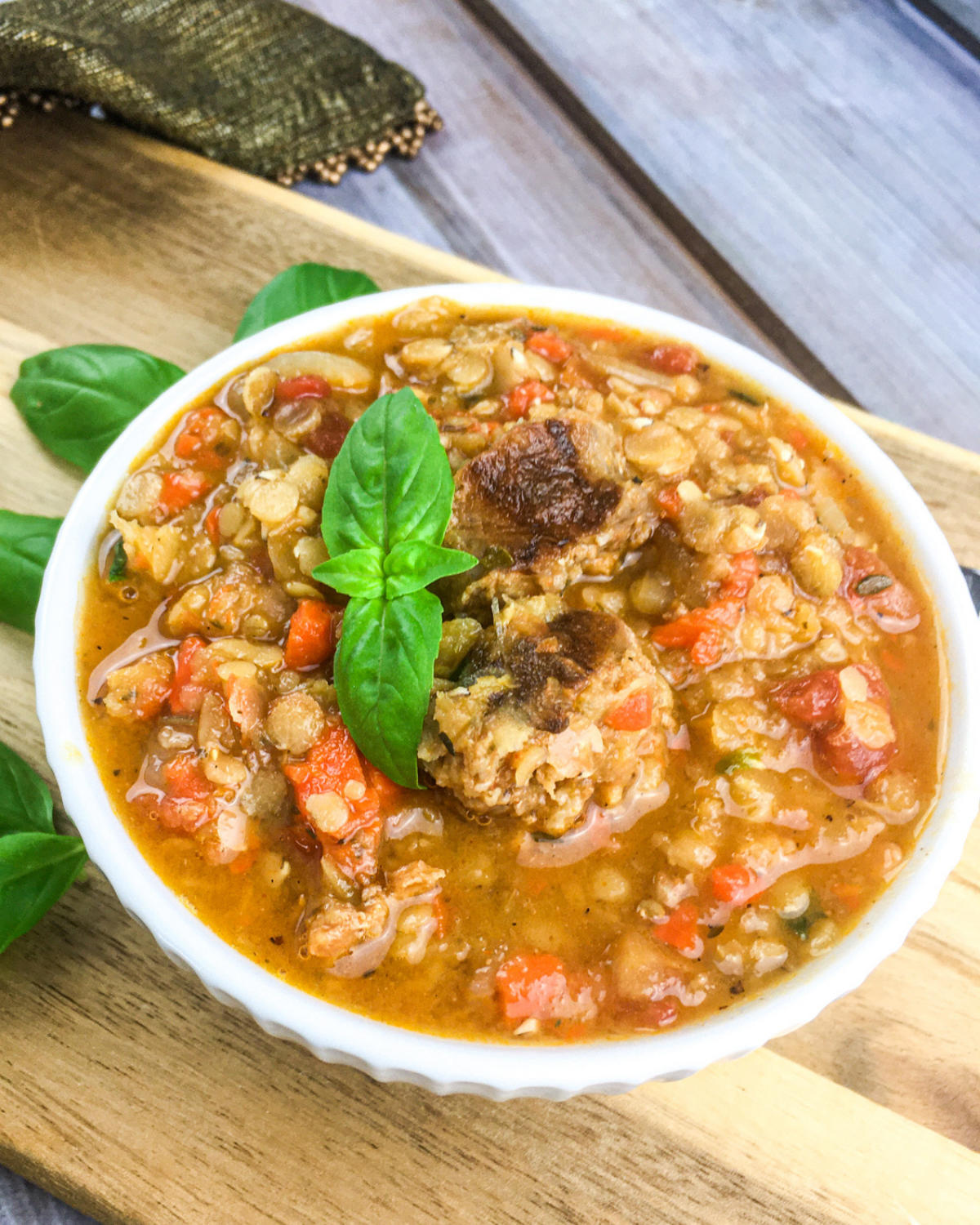 close up of lentil and chorizo soup with diced vegetables and sausage