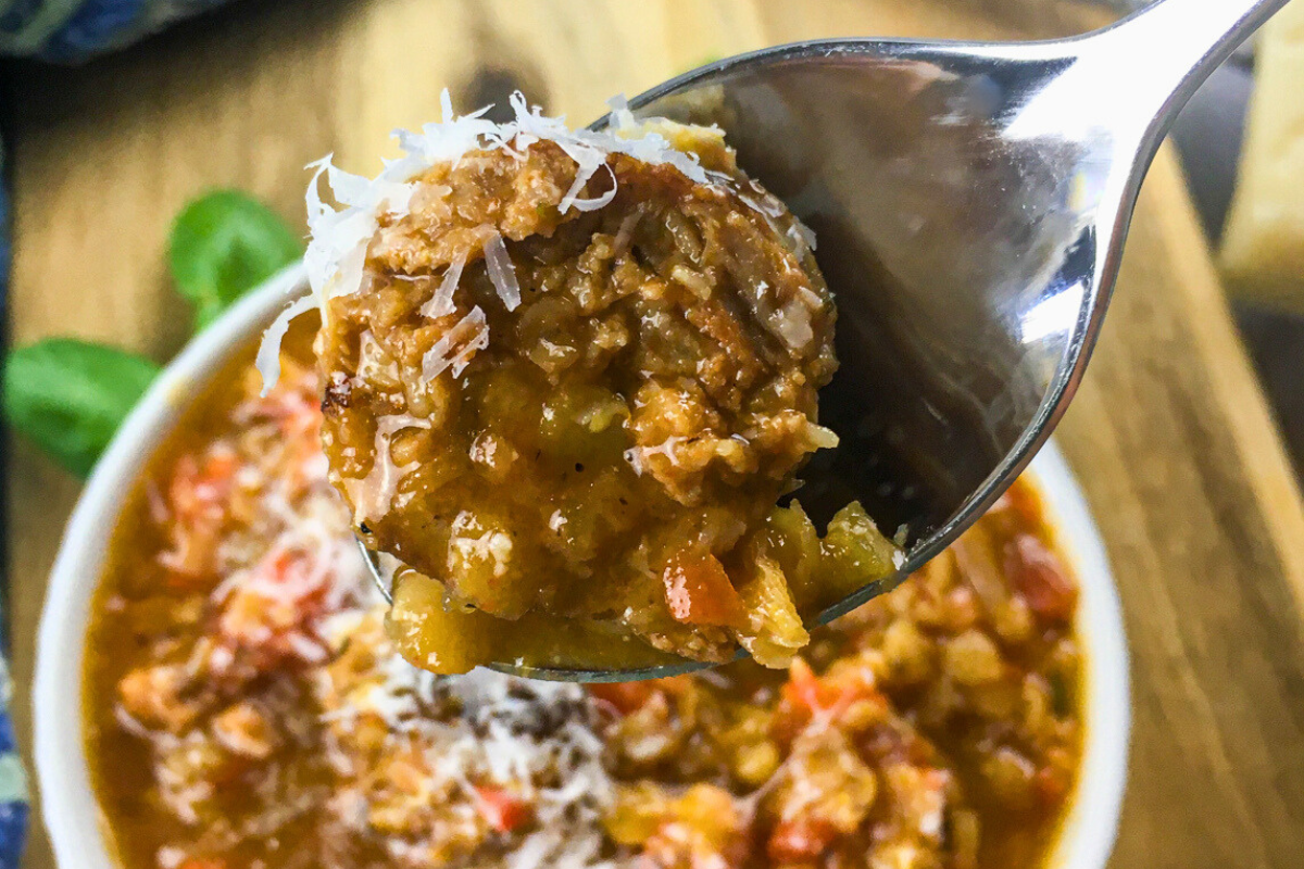 spoonful of lentejas con chorizo showing lentils sausage and vegetables