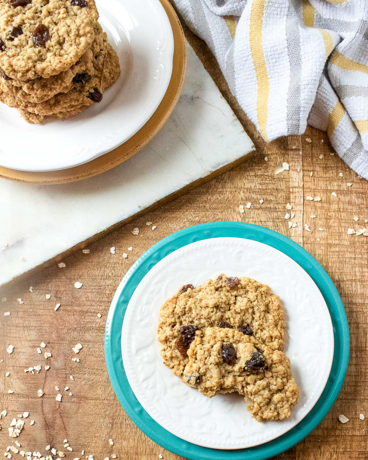 Oatmeal raisin cookies on plate with bite taken showing chewy texture and raisins