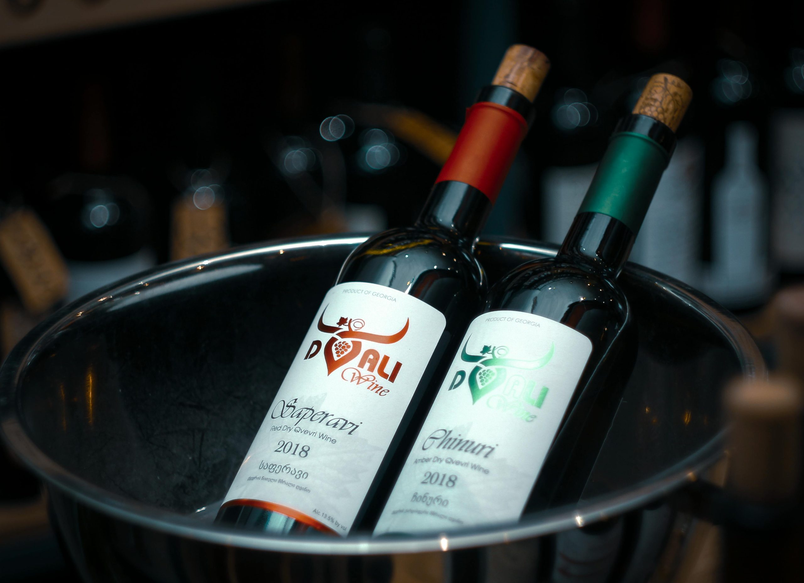 Two wine bottles with corks in ice bucket, perfect for wine tasting and events.
