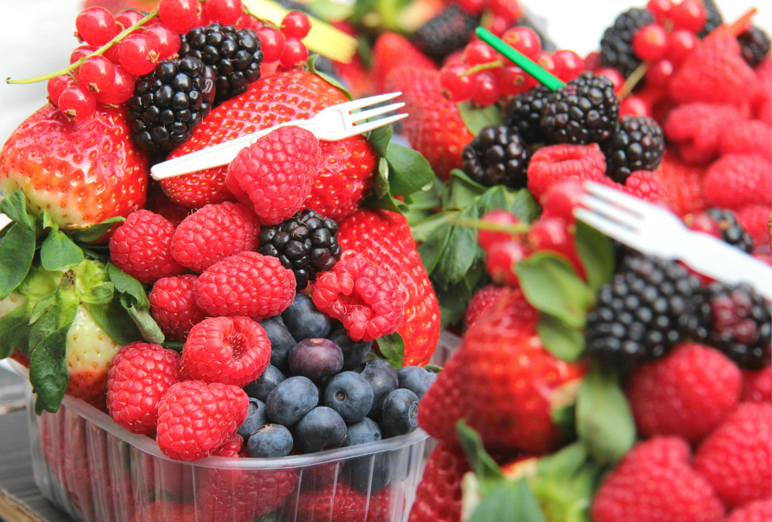 A vibrant assortment of fresh berries including strawberries, raspberries, blueberries, and blackberries.