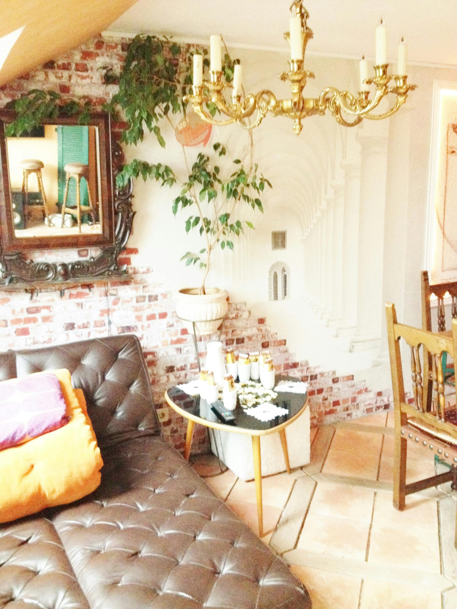 A modern living room featuring vintage decor elements and a brick wall design.