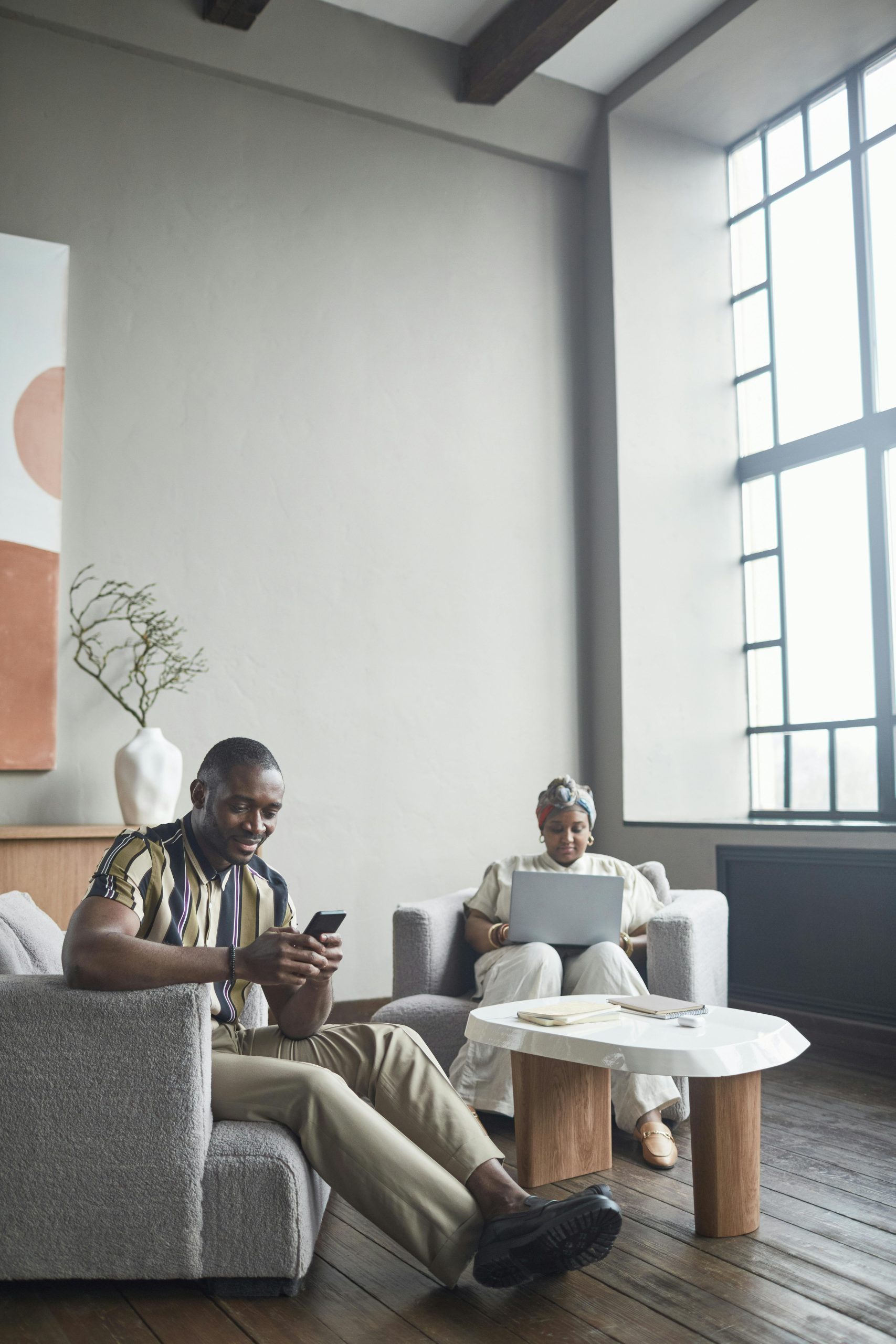 Two colleagues working in a stylish office with tech devices and modern design.