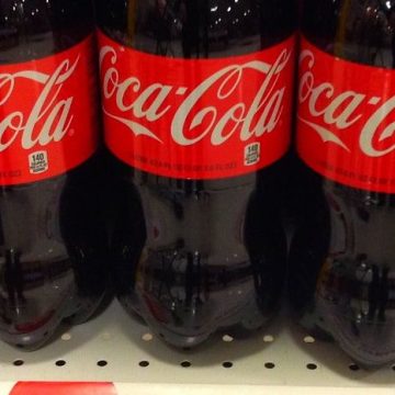 Here's The Real Reason Coca-Cola Bottles Have Yellow Caps Right Now