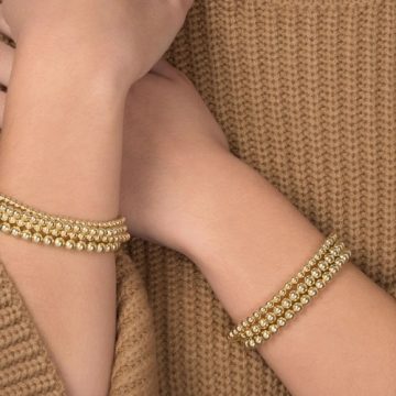 hands with gold jewelry