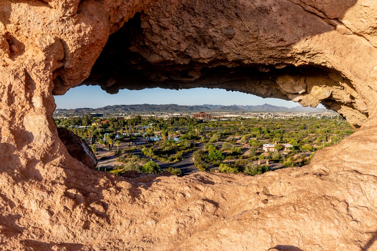 Capture of Phoenix cityscape through a unique rock formation in Papago Park, Arizona.